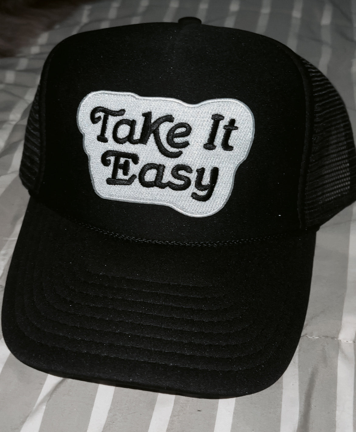 black hat with black and white "take it easy" patch